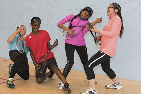 Standing children play air guitar